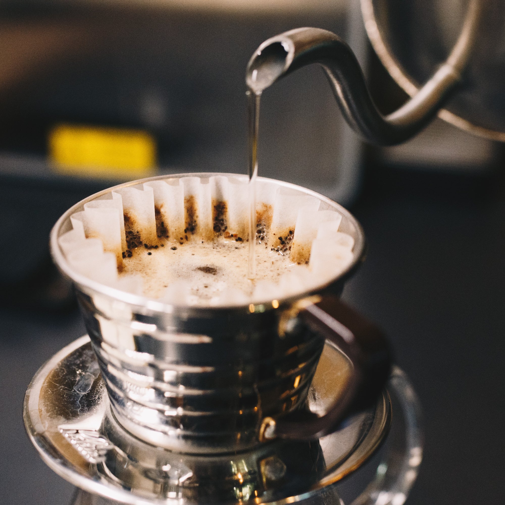 Hot water being poured over a pour over style coffee maker