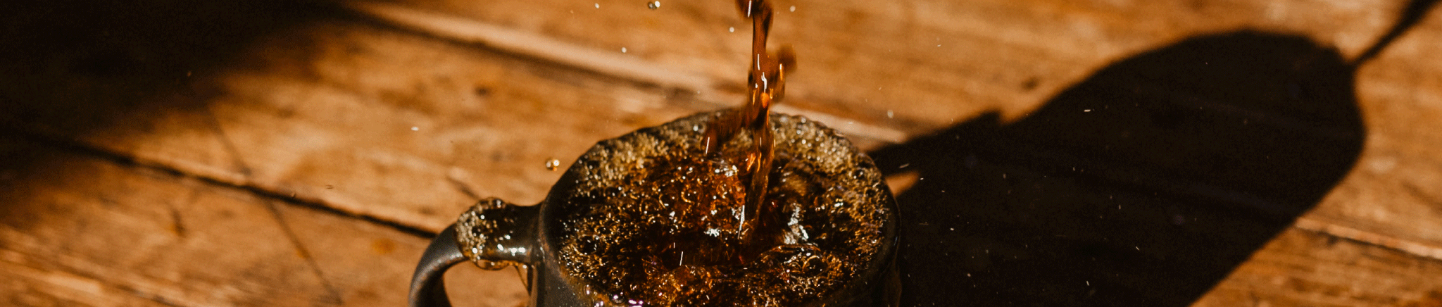 Coffee pouring into a mug and splashing