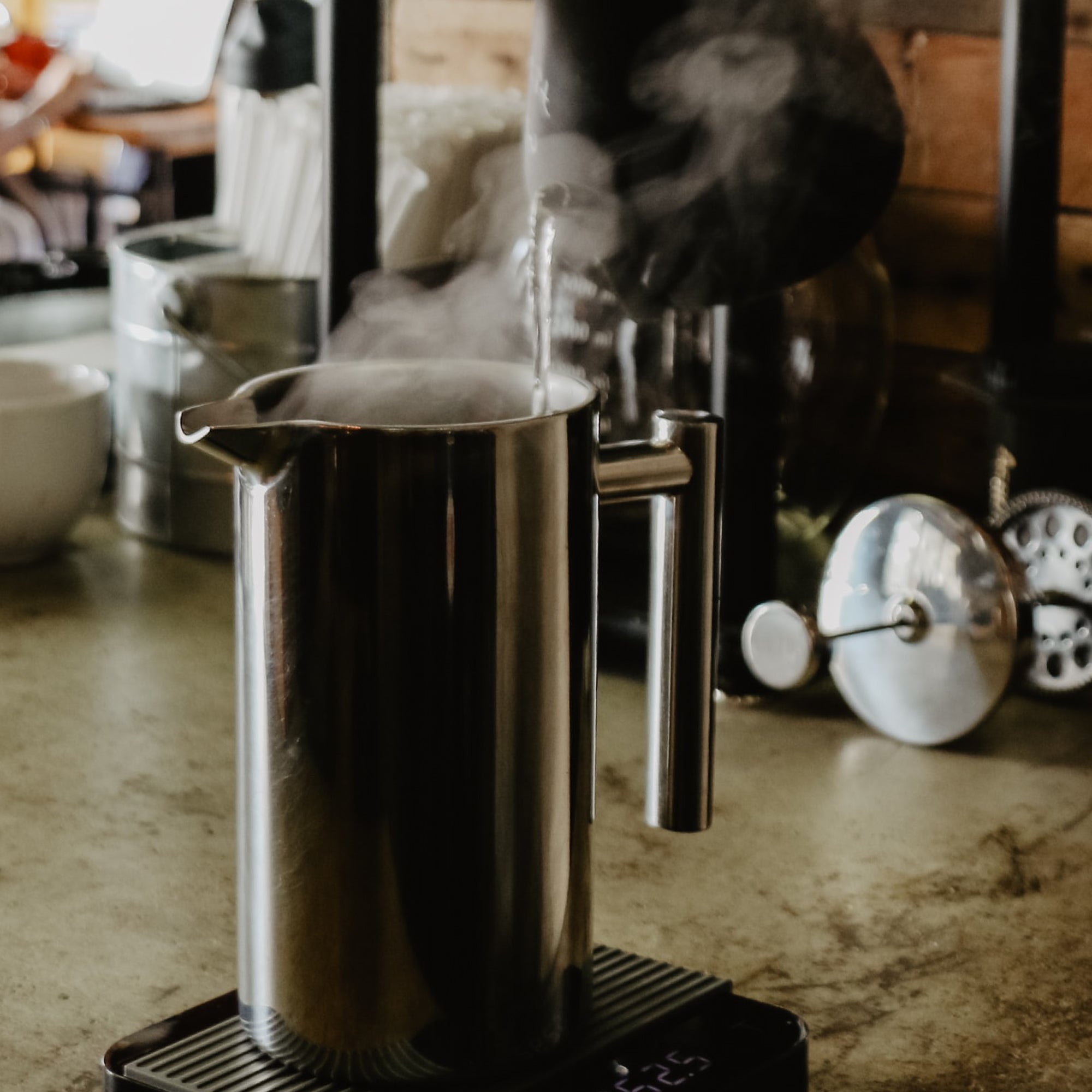Hot water being poured into a French Press coffee brewer