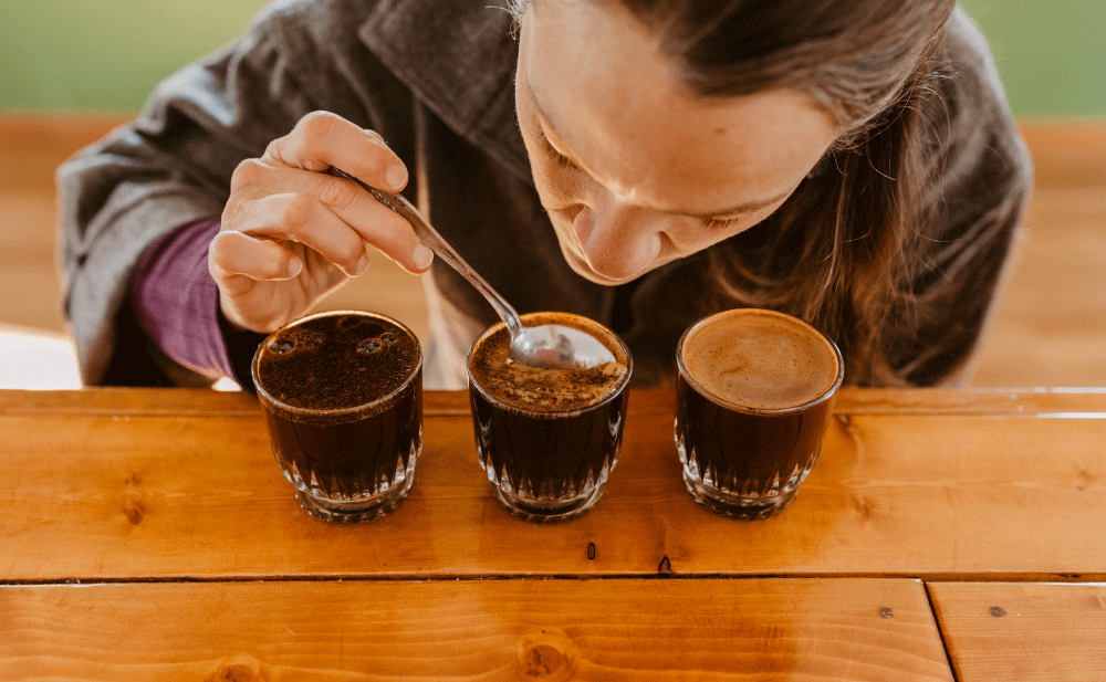A woman sampling freshly brewed coffee