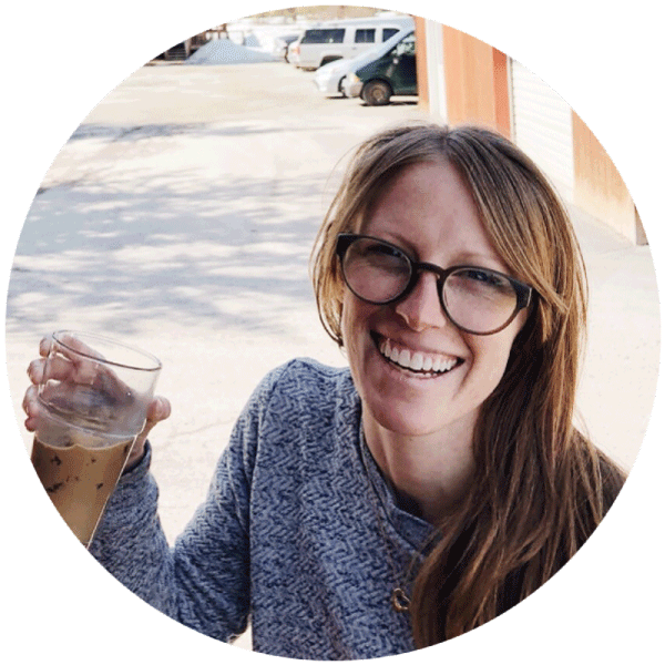 A smiling woman holding a cup of coffee