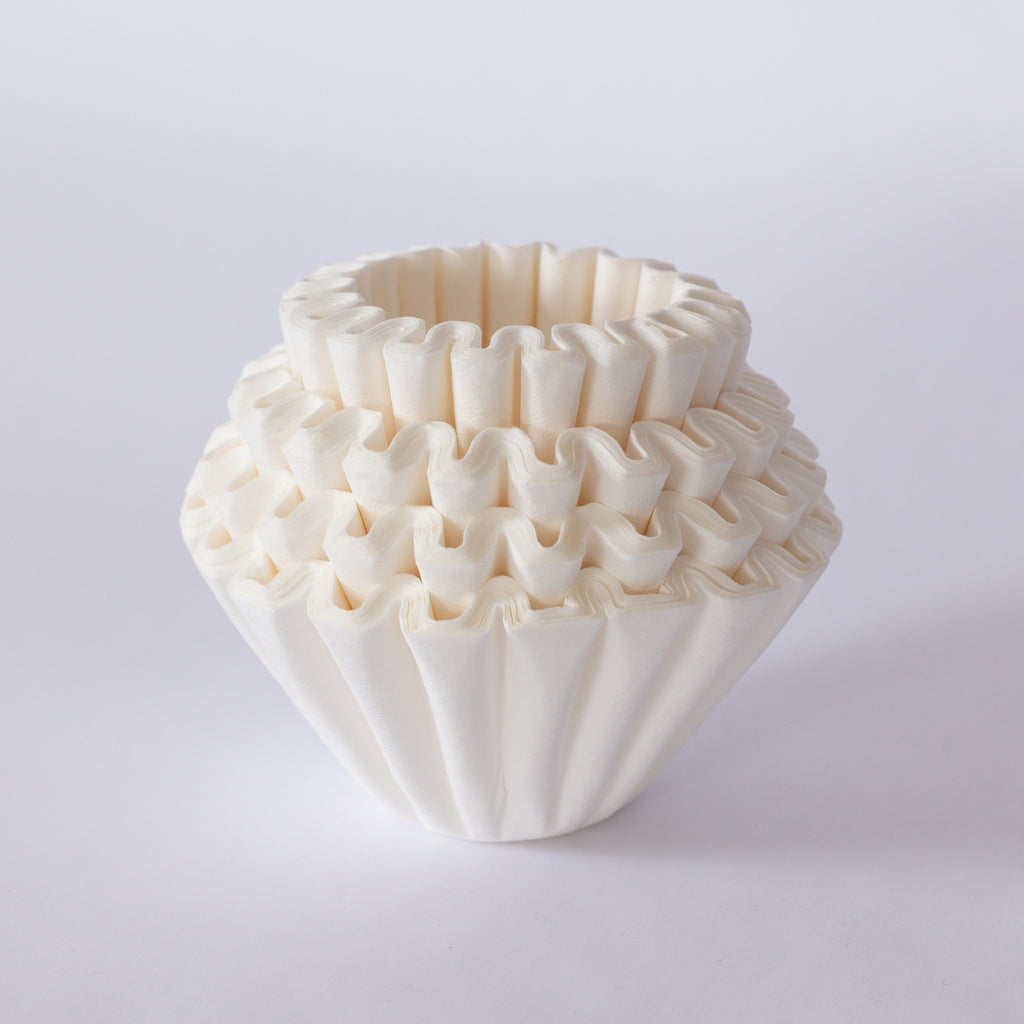 Paper coffee filters in a stack.